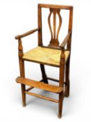 19TH CENTURY OAK CHILD'S ARMCHAIR having pierced splat back, rush seat, turned supports and
