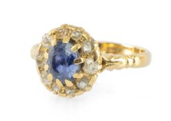 SAPPHIRE & DIAMOND RING, central oval mid-blue sapphire in a raised ten-claw setting surrounded by