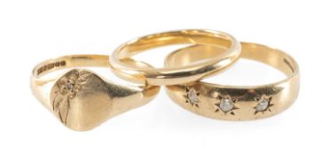 THREE 9CT GOLD RINGS, comprising plain band, engraved with diamond chip, and three-stone diamond '