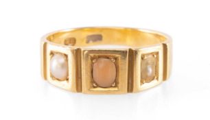 18CT GOLD RING, the centre oval coral bead flanked by split pearl to either side, ring size R, 5.