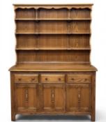 ERCOL DRESSER IN 'GOLDEN DAWN' MID-TONE FINISH, with three-shelf rack and three drawer and