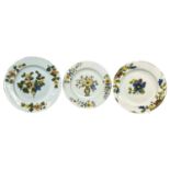 THREE DELFTWARE FAZACKERLEY FLORAL DECORATED PLATES, c. 1760, 24cms (diam.) the larger Provenance:
