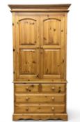 MODERN PINE TWO-DOOR WARDROBE having four base drawers, 204 (h) x 108 (w) x 61cms (d) Provenance: