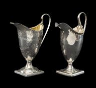 TWO GEORGE III SILVER HELMET-SHAPED CREAM JUGS, one with bright-cut decoration, gilt interior, and