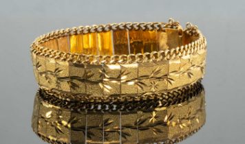 YELLOW METAL BRACELET, matt finish, engraved with floral motifs, clip-type closure with hook and