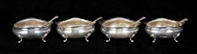 SET OF FOUR EDWARD VII OVAL SILVER OPEN SALTS, each on four pad feet, Holland Aldwinckle & Slater,