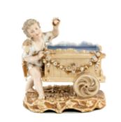 MEISSEN FLOWER HOLDER, late 19th century, modelled as Eros with floral festooned cart, blue