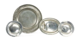FOUR ANTIQUE PEWTER DISHES, including a pair of plates, oval bowl with asymmetric depression,