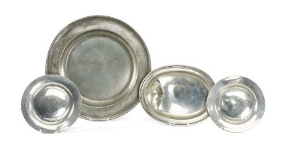 FOUR ANTIQUE PEWTER DISHES, including a pair of plates, oval bowl with asymmetric depression,