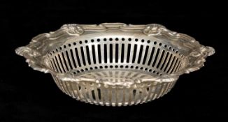 EDWARDIAN CIRCULAR SILVER BON BON DISH, the rim moulded and with shell motifs, pierced sides,