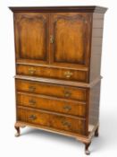 QUEEN ANNE REVIVAL WALNUT PRESS CHEST, having two cupboard doors opening to a single shelf, on a