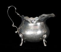 EDWARD VII SILVER CREAM JUG with shaped rim, loop handle, on four paw feet, George Nathan & Ridley