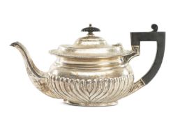 EDWARD VII OVAL SILVER TEAPOT, gadrooned, having ebonised handle and finial, Joseph Rodgers &