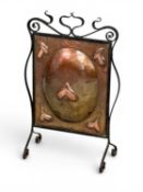 ARTS & CRAFTS REPOUSSE COPPER FIRESCREEN decorated with five seed-pods, early 20th Century, Newlyn /