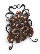 ART NOUVEAU SHIELD SHAPED REPOUSSE COPPER FIRE SCREEN decorated with fluid branching plant, iron