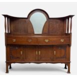 ARTS & CRAFTS OAK SIDEBOARD, mirrored gallery raised on turned spindles, carved botanical motifs,