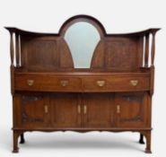 ARTS & CRAFTS OAK SIDEBOARD, mirrored gallery raised on turned spindles, carved botanical motifs,