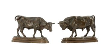 PAIR OF BRONZE MODELS OF CATTLE, the bull and cow striding on long oval bases, stepped plinths, 10.