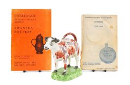 SWANSEA POTTERY COW CREAMER, standing four square on domed grassy base, with cover, 18.5cms (w);