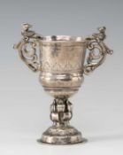 ANDEAN SILVER MINIATURE CHALICE, 19th Century, with scrolled bird handles, foliate engraved bowl
