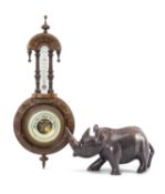 CARVED WALNUT ANEROID BAROMETER & AFRICAN SOAPSTONE RHINO, barometer dial 12.5cms (diam.), 60cms (