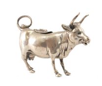GERMAN 800 STANDARD SILVER COW CREAMER of conventional standing form, hinged oval floral engraved