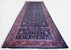 PERSIAN HAMADAN STYLE GALLERY CARPET, flower, palmette and vine indigo field, madder stylised floral