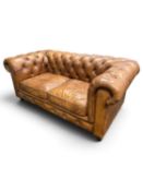 CHESTERFIELD TWO-SEATER SETTEE upholstered in brown deep button leather, 178 (w) x 93cms (d)