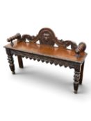 VICTORIAN GOTHIC REVIVAL OAK HALL BENCH, back pierced and carved with mask head, turned armrests,