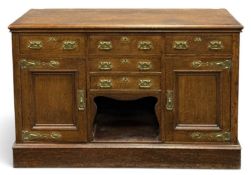 LATE VICTORIAN OAK ENCLOSED DRESSER BASE in the Arts & Crafts style, fitted with Art Nouveau style