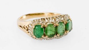 YELLOW METAL EMERALD & DIAMOND RING, set with a row of four oval cut emeralds, within diamond