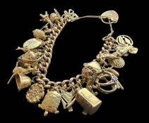 9CT GOLD CURB-LINK CHARM BRACELET with stamped links and supporting thirty charms, four of which are