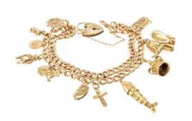 9CT GOLD CHARM BRACELET, rose gold double curb link with 11 yellow metal charms, padlock clasp,