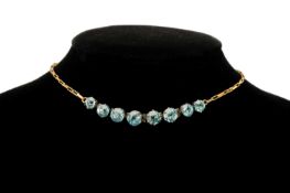 AQUAMARINE CHOKER NECKLACE in 9ct gold, set with eight round-cut stones graduating in size, in