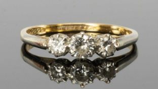DIAMOND THREE-STONE RING in 18ct gold and platinum, set with three brilliant-cut stones, the