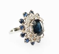 WHITE METAL SAPPHIRE & DIAMOND RING, central oval sapphire approx. 10 x 8mm, within double border of