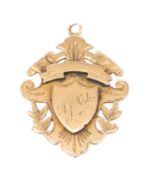 9CT GOLD SHIELD PENDANT, engraved 'A. J. Perks', 9.6g Provenance: private collection