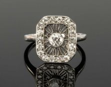 ART DECO DIAMOND CLUSTER RING centred with an old round-cut diamond of approx. 0.25ct in platinum