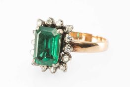 YELLOW METAL BELIEVED SYNTHETIC EMERALD & DIAMOND RING, set with a rectangular-cut emerald approx.