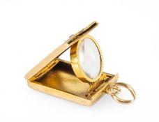 NOVELTY YELLOW METAL DIAMOND & ENAMEL MAGNIFYING GLASS LOCKET, rectangular with rose-cut diamond