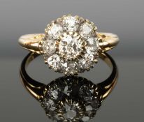 ANTIQUE DIAMOND CLUSTER RING set with nine old cushion-cut stones, the central stone estimated as