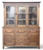 EARLY 19TH CENTURY OAK WELSH DRESSER with three glass door top, base of three opening drawers over