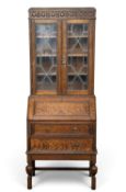 EDWARDIAN OAK BUREAU BOOKCASE, upper section with leaded glass doors, drop-down mid-section over two
