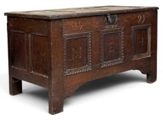 19TH CENTURY OAK THREE-PANEL COFFER with carved 'N.E.H. 1597', 61 (h) x 113 (w) x 57cms (d)