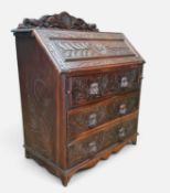 ANTIQUE FLEMISH 'GREEN MAN' CARVED OAK BUREAU, foliate carved fall-front with part fitted