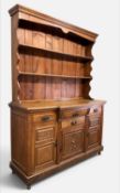 EDWARDIAN CARVED OAK DRESSER, boarded plate rack, breakfront lower section with three frieze
