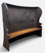 19TH CENTURY BARREL-BACK TAVERN SETTLE, high curved wind-shield back, shaped scroll arms, solid