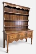 SMALL 20TH CENTURY OAK DRESSER, boarded plate rack, lower section with three deep frieze drawers,