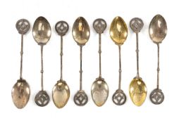 MASONIC INTEREST: SET OF EIGHT GEORGE V SILVER TEASPOONS, the handle terminals pierced with square