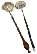 TWO GEORGIAN TODDY LADLES, one having ornate repoussé bowl and turned wooden handle, 31cms (l);
